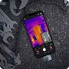A smartphone with a thermal imaging app open is placed on a rough surface surrounded by tools and a chain. Voir les images du produit
