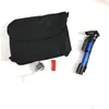A black bag and a blue pump are laid out on a white surface. Anteprima dell’immagine prodotto