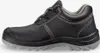 A side view of a black safety shoe with a gray sole. Produktbild-Vorschau
