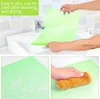 Collage of images showing a green mat being held over a sink, a close-up of the mat with water drops, and a hand cleaning the mat with a sponge. Produktbild-Vorschau
