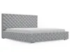 A gray upholstered bed frame with a tufted headboard and footboard, shown from a side angle against a white background. Produktbild-Vorschau