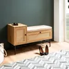 A shoe bench with storage in a hallway next to a window, with shoes and a bag nearby. Voir les images du produit