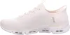A side view of a beige Skechers sneaker against a white background. Voir les images du produit