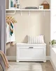 A closet organization scene featuring a white storage bench with a pillow, clothes on hangers, and a shelf with accessories. Produktbild-Vorschau