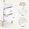 A close-up of a white marble-patterned rolling cart with gold accents, showing its drawers and shelves. Produktbild-Vorschau