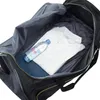 Inside of an open black duffel bag with a white polo shirt and a bottle of Evian water. Voir les images du produit