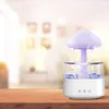 A mushroom-shaped humidifier with a purple light is shown on a wooden table, with a blurred background of a room. Voir les images du produit
