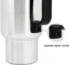 Close-up of a stainless steel travel mug with a black handle, showing a detail of the cigarette lighter socket. Anteprima dell’immagine prodotto