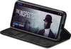 A smartphone in a black flip case is displayed on a surface, showing a movie poster on its screen. Produktbild-Vorschau