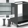 A 3D rendering of kitchen cabinet components, including a partially assembled base cabinet and a wall cabinet with glass doors. Produktbild-Vorschau