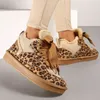 A close-up shot of a person wearing leopard-print winter sneakers. Produktbild-Vorschau