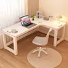 A white L-shaped computer desk with a laptop, a lamp, and a chair in a room. Produktbild-Vorschau