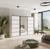 A modern bedroom scene with a large sliding door wardrobe, a plant, and seating. Produktbild-Vorschau