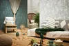 A bohemian-style living room setup with a bed, chair, and decorative items. Produktbild-Vorschau