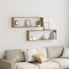 Two wooden cube shelves mounted on a white wall above a sofa. Produktbild-Vorschau