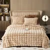 A plush blanket is neatly arranged on a bed, with pillows and a cup of coffee. Náhled obrázku produktu