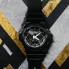 A black Casio G-Shock watch is displayed on a textured background with black, gold, and gray geometric patterns. Náhled obrázku produktu