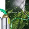 A submersible pump connected to a green hose spraying water onto a grassy lawn. Náhled obrázku produktu