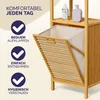 A close-up view of a bamboo bathroom shelf with an open laundry basket, featuring marketing text and icons. Produktbild-Vorschau