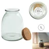 A glass jar with a cork lid, shown from multiple angles, with a label and size indicator. Produktbild-Vorschau
