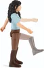 A toy figurine of a girl in riding attire, shown from the side with one leg raised as if walking or trotting. Produktbild-Vorschau