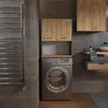 A modern bathroom with a washing machine, cabinets, and a heated towel rack. Produktbild-Vorschau