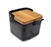 A black ceramic sugar bowl with a wooden lid and a small spoon. Anteprima dell’immagine prodotto