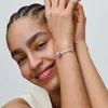 A woman's wrist with a Pandora charm bracelet. Anteprima dell’immagine prodotto