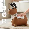 A brown dog-shaped inflatable toy is being wiped with a cloth, with informational icons on the left. Produktbild-Vorschau