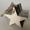 A close-up of a wooden star ornament with jute twine. Produktbild-Vorschau