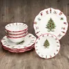 A set of Christmas-themed dinnerware is displayed on a wooden surface. Náhled obrázku produktu