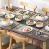 A dining table set for a meal with plates, bowls, food, and cutlery. Náhled obrázku produktu
