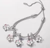 A silver bracelet with flower charms. Produktbild-Vorschau