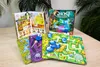 Board game components laid out on a wooden table with plants in the background. Produktbild-Vorschau