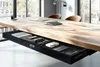 A close-up shot of a wooden table with an open drawer underneath, showcasing office supplies. Podgląd zdjęcia produktu