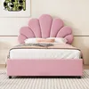 A pink upholstered bed with a shell-shaped headboard is shown in a bedroom setting. Anteprima dell’immagine prodotto