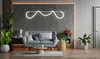 A modern living room with a sofa, plants, and a decorative lamp. Produktbild-Vorschau