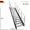 A metal staircase with metal grating steps and railings, shown against a white background. Náhled obrázku produktu