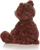 A brown teddy bear is sitting on a white surface. Anteprima dell’immagine prodotto