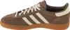 Side view of a brown Adidas Handball Spezial sneaker with cream accents and laces, set against a white background. Voir les images du produit