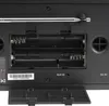 The back of a portable radio showing the battery compartment, antenna, and input/output ports. Voir les images du produit