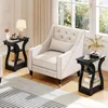 A living room scene with two black side tables and a cream-colored armchair. Produktbild-Vorschau
