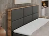A close-up view of a bed with a dark gray upholstered headboard and a wooden frame. Produktbild-Vorschau