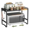 A kitchen counter with a microwave and an expandable shelf above it. Produktbild-Vorschau