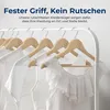 A rack of white shirts hanging on wooden hangers. Produktbild-Vorschau