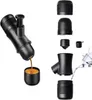 A black portable espresso machine is shown with its components laid out separately. One part of the machine is actively dispensing espresso into a small cup. Produktbild-Vorschau