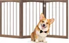 A corgi dog wearing a bow tie sits in front of a wooden pet gate. Podgląd zdjęcia produktu