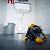 A work light is placed on the floor in front of a sink in a bathroom or utility room. Produktbild-Vorschau
