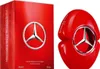 A red perfume bottle and its packaging are displayed side-by-side against a white background. Voir les images du produit