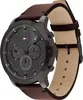 A close-up, angled view of a Tommy Hilfiger men's watch with a dark gray face and a brown leather strap. Anteprima dell’immagine prodotto